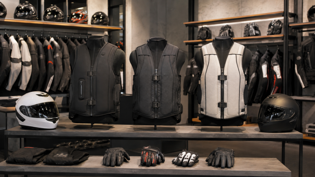 Motorcycle airbag vests displayed with helmets and armored jackets